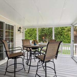 Screened Porch w/composite decking and sliding glass doors to the sunroom as well as the primary bedroom.