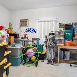 Detached garage office/store area, finished space with a wall air conditioner unit.