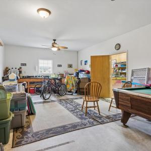 Large room in detached garage, behind the garage bay, plumbed with a sink.