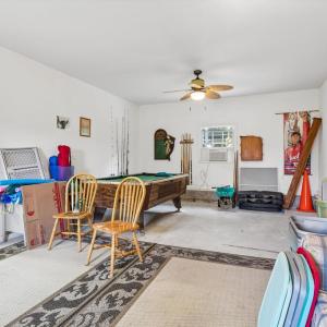 Large room in detached garage, behind the garage bay, plumbed with a sink.