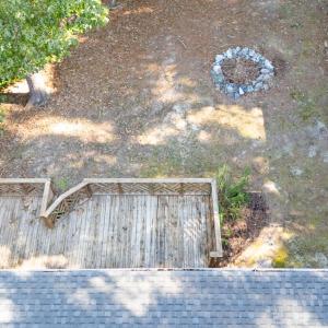 Aerial showing house, deck, fire pit and shed