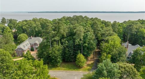 Aerial view of beautiful wooded waterfront lot.