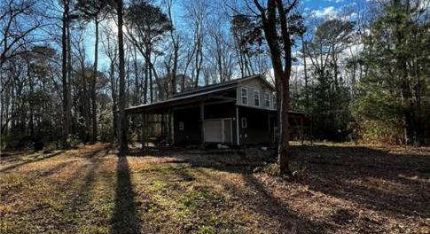 Two story barn with RV parking on the side.