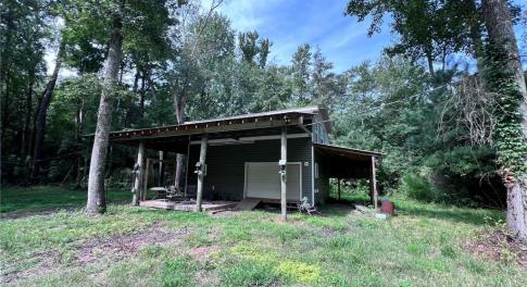 Two story barn with RV parking on the side.