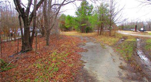 Paved asphalt drive at the entrance.