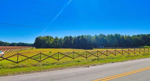 View of asphalt street with a rural view