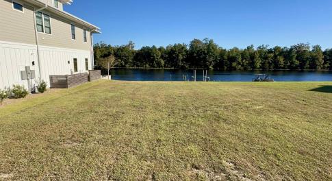 View of grassy yard with a water view