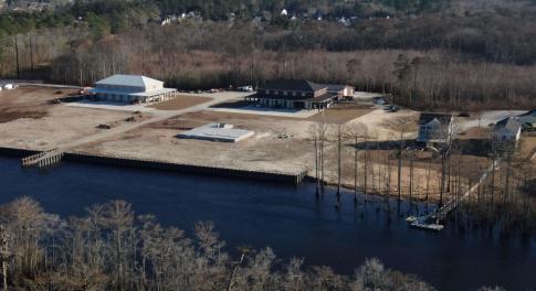 Birds eye view of property with a water view