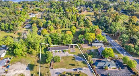 Birds eye view of property with a water view