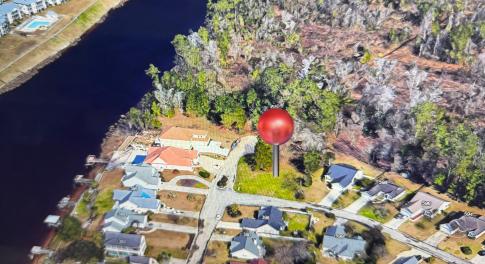 Bird's eye view featuring a water view and a resid