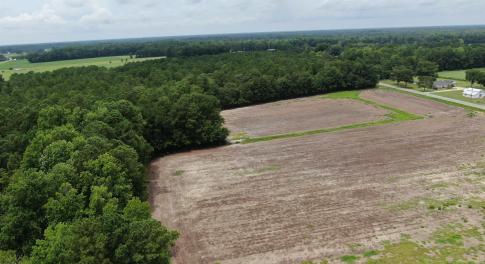 Bird's eye view featuring a wooded view and a rura