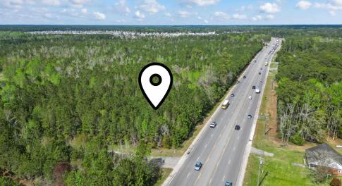 Aerial view featuring a forest view
