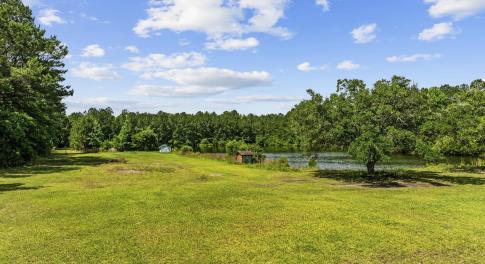 View of grassy yard featuring a water view, a view