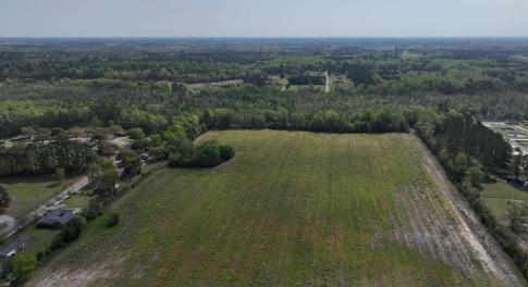 View of property location with a heavily wooded ar