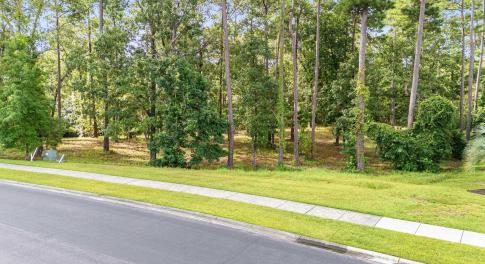 View of asphalt road with sidewalks and curbs