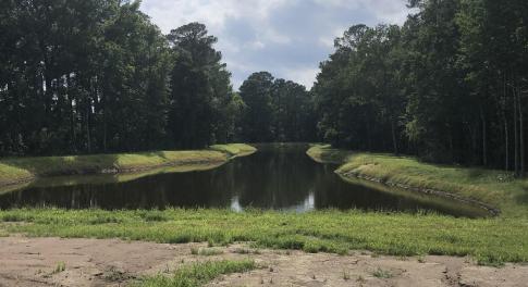 Surrounding community with a view of trees and a w