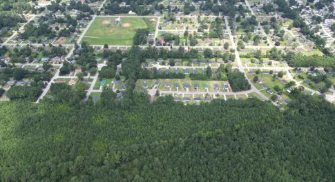 Aerial view of property's location with a forest