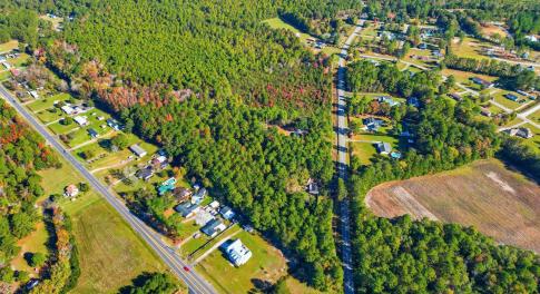 Aerial view of property's location with a forest