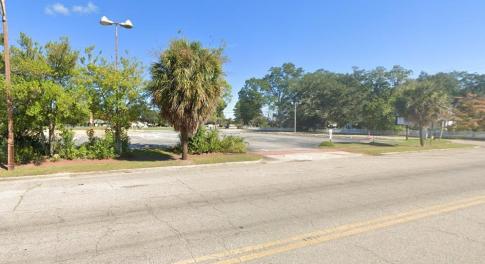 View of asphalt street featuring street lighting a