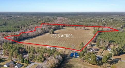 Aerial view of property's location with a forest a