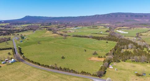Beautiful mountain views from this mostly open parcel of land.  The pond is in view, and the stream is in the forested area that runs left to right across the back 1/3 of the parcel.