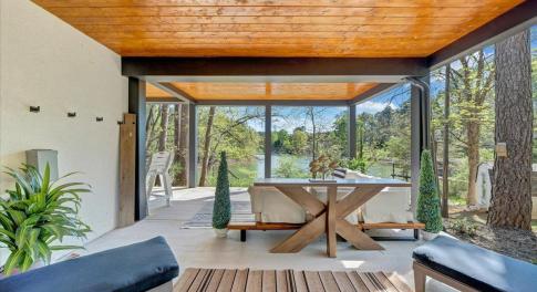 a seamless blend of elegance and openness, this property features expansive outdoor living areas to rival its sophisticated indoor spaces overlooking the breathtaking beauty of Smith Mountain Lake!
